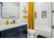 Stylish bathroom with a navy vanity, black and white floor tiles, and a contrasting yellow shower curtain at 245 Mathewson Pl, Atlanta, GA 30314