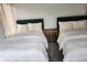 Bright bedroom featuring two beds with white linens and a nightstand between them at 245 Mathewson Pl, Atlanta, GA 30314