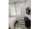 Modern bedroom with a mounted TV, black dresser, and sheer curtains creating a bright and airy atmosphere at 245 Mathewson Pl, Atlanta, GA 30314