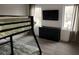 Bedroom with bunk bed, black dresser, and mounted TV, with views from two windows at 245 Mathewson Pl, Atlanta, GA 30314