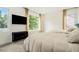 Bright bedroom with two cozy beds, a large window, and modern black dresser, perfect for relaxation at 245 Mathewson Pl, Atlanta, GA 30314