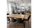 Dining area with kitchen in the background, featuring stainless steel appliances, modern cabinets, and a center island at 245 Mathewson Pl, Atlanta, GA 30314