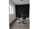 Modern dining area features a sleek black accent wall, round table and seating, and plenty of natural light at 245 Mathewson Pl, Atlanta, GA 30314