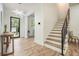 Bright entryway featuring modern light fixture, wood floors, a unique table, and a view of the stairs at 245 Mathewson Pl, Atlanta, GA 30314
