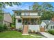 Modern two-story home with a covered porch, landscaped yard, and wooden steps leading to the entrance at 245 Mathewson Pl, Atlanta, GA 30314