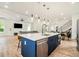 Open-concept kitchen with blue island, stainless steel appliances, and seamless flow into the living area at 245 Mathewson Pl, Atlanta, GA 30314