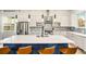Bright kitchen features a central island with seating, stainless steel appliances, and modern white cabinetry at 245 Mathewson Pl, Atlanta, GA 30314