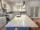 Bright kitchen featuring a large center island with seating, modern pendant lighting, and stainless steel appliances at 245 Mathewson Pl, Atlanta, GA 30314