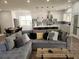 Open floor plan of the living room featuring an oversized couch and view into the kitchen at 245 Mathewson Pl, Atlanta, GA 30314