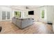 Bright and airy living room with a large gray sectional couch, fireplace, and abundant natural light at 245 Mathewson Pl, Atlanta, GA 30314