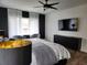 Main bedroom with a ceiling fan, TV, sitting area, and natural light at 245 Mathewson Pl, Atlanta, GA 30314