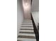 Modern staircase with wood steps and black metal railings offers a stylish transition between floors at 245 Mathewson Pl, Atlanta, GA 30314