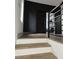 Modern staircase with wood steps, black accent wall, and metal railings offers a stylish transition between floors at 245 Mathewson Pl, Atlanta, GA 30314