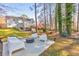 A spacious backyard with patio furniture and mature trees provides a park-like setting at 2867 Watchtower Approach Nw, Marietta, GA 30064