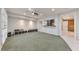 Basement area with projector, cabinets, and half wall access to a finished and decorated room at 2867 Watchtower Approach Nw, Marietta, GA 30064