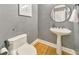 Powder room with gray walls, wooden floors and a pedestal sink at 2867 Watchtower Approach Nw, Marietta, GA 30064