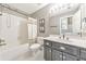 Bathroom featuring a shower-tub combo, modern vanity, and neutral-toned decor at 2867 Watchtower Approach Nw, Marietta, GA 30064