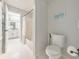 Bathroom featuring a shower-tub combo, tiled floors, and access to another room at 2867 Watchtower Approach Nw, Marietta, GA 30064