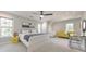 Bright bedroom features a ceiling fan, modern art, and a cozy sitting area with bright yellow chairs at 2867 Watchtower Approach Nw, Marietta, GA 30064