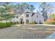Stately two-story home with a manicured lawn and lush landscaping at 2867 Watchtower Approach Nw, Marietta, GA 30064