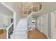 Bright foyer featuring a white staircase, hardwood floors, and elegant lighting at 2867 Watchtower Approach Nw, Marietta, GA 30064