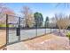 Community tennis court surrounded by mature trees and landscaping at 2867 Watchtower Approach Nw, Marietta, GA 30064