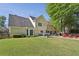 Wide shot of large backyard with firepit, outdoor dining area, lush lawn, and mature trees at 3034 Bristlewood Nw Ln, Marietta, GA 30064