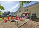 Backyard with gravel firepit, red Adirondack chairs, lawn, and outdoor dining space at 3034 Bristlewood Nw Ln, Marietta, GA 30064