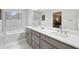 Bathroom features a double vanity with marble countertop, a soaking tub, and modern fixtures at 3034 Bristlewood Nw Ln, Marietta, GA 30064