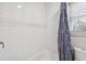 Close up of bathroom featuring shower with white subway tile and blue shower curtain at 3034 Bristlewood Nw Ln, Marietta, GA 30064
