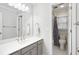 Bright bathroom with a large mirror, gray cabinets, and an open shower area showcasing modern fixtures at 3034 Bristlewood Nw Ln, Marietta, GA 30064