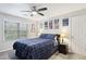 Bedroom with a cozy queen-sized bed, ceiling fan, and bright window at 3034 Bristlewood Nw Ln, Marietta, GA 30064