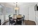 Bright breakfast nook with round table, large windows, and stylish light fixture at 3034 Bristlewood Nw Ln, Marietta, GA 30064