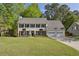 Beautiful two-story home with a well-manicured lawn, three-car garage, and elegant landscaping at 3034 Bristlewood Nw Ln, Marietta, GA 30064
