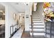 Welcoming foyer with staircase, decorative console table, and stylish decor at 3034 Bristlewood Nw Ln, Marietta, GA 30064