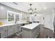 Modern kitchen features stainless steel appliances, white countertops, an island, and sleek lighting at 3034 Bristlewood Nw Ln, Marietta, GA 30064