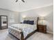 Main bedroom suite with a tufted headboard bed, side tables, and carpeted floors at 3034 Bristlewood Nw Ln, Marietta, GA 30064