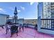 Rooftop balcony with lounge chairs, tables, and expansive city views at 275 13Th Ne St # 310, Atlanta, GA 30309