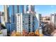Aerial view of a high-rise condo building with balconies and vibrant fall foliage at 275 13Th Ne St # 310, Atlanta, GA 30309