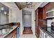 Efficient kitchen features sleek black counters, stainless appliances, and rich wood cabinetry at 275 13Th Ne St # 310, Atlanta, GA 30309