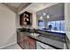 Elegant kitchen featuring dark granite countertops, stainless steel appliances, and a pass-through to the living room at 275 13Th Ne St # 310, Atlanta, GA 30309
