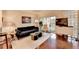 Comfortable living room with hardwood floors, a balcony, contemporary furniture, and abundant natural light at 275 13Th Ne St # 310, Atlanta, GA 30309