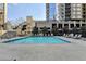 Outdoor swimming pool surrounded by lounge chairs and lush landscaping at 275 13Th Ne St # 310, Atlanta, GA 30309