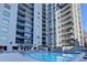 Swimming pool surrounded by lounge chairs with a tall condo building in the background at 275 13Th Ne St # 310, Atlanta, GA 30309
