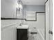 Bathroom featuring white tile walls, black trim, and a vanity with updated fixtures at 621 Spruce Dr, Stone Mountain, GA 30083