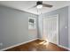 Bedroom with hardwood floors, a ceiling fan, window, and a large closet at 621 Spruce Dr, Stone Mountain, GA 30083