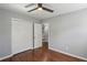 Bedroom with hardwood floors, neutral walls, ceiling fan, and closet doors at 621 Spruce Dr, Stone Mountain, GA 30083