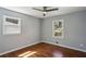 Bedroom featuring hardwood floors, neutral walls, two windows, and trim at 621 Spruce Dr, Stone Mountain, GA 30083