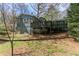 Back exterior view of home featuring a spacious deck and lush greenery at 621 Spruce Dr, Stone Mountain, GA 30083
