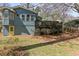 Back exterior view of home with deck overlooking large back yard at 621 Spruce Dr, Stone Mountain, GA 30083